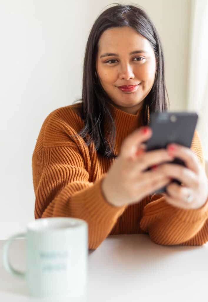 woman holding camera taking a selfie